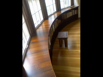 Custom built curved Ipe and Walnut bookcase to match curve of house